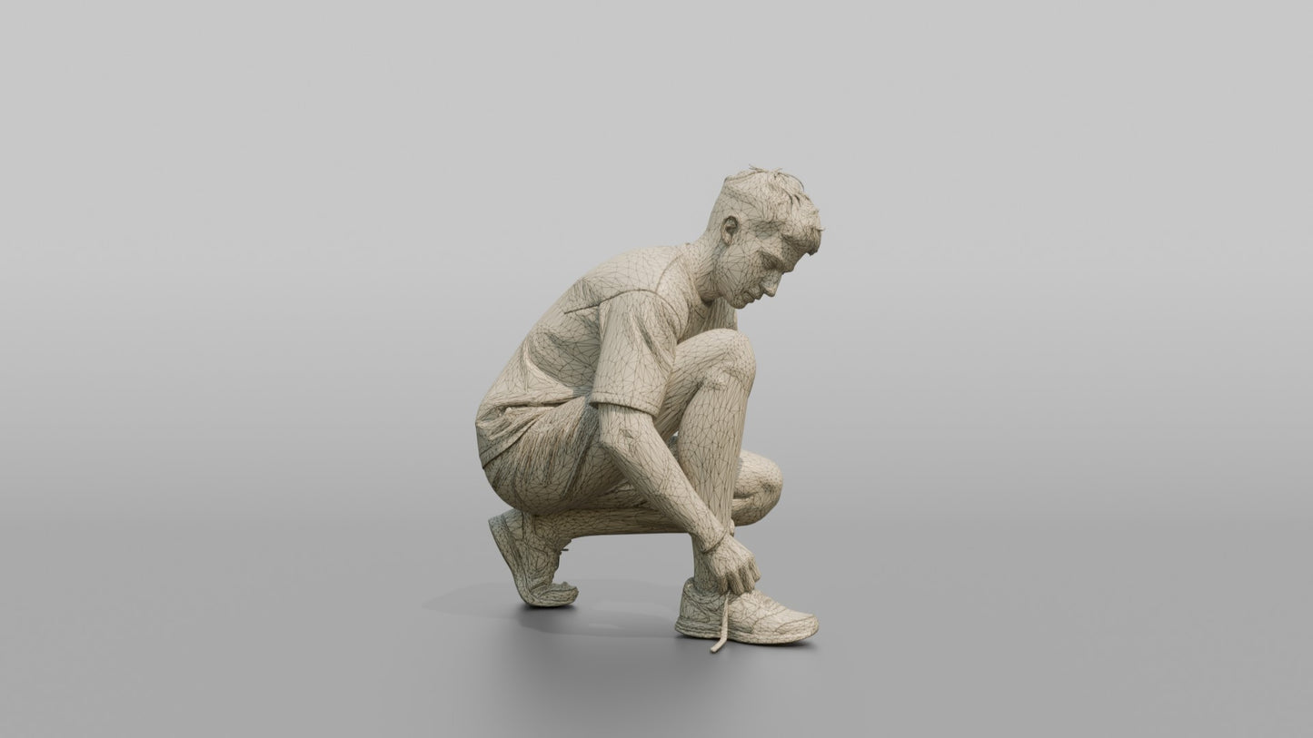 Man Crouching to Retie His Sneakers