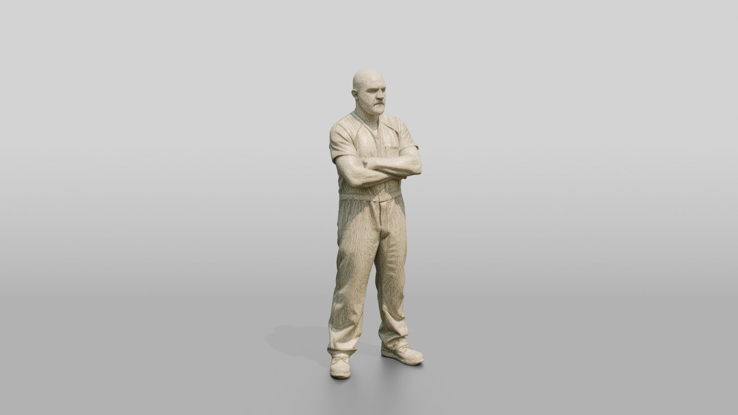 White Male Prisoner Standing with His Arms Crossed Defensively