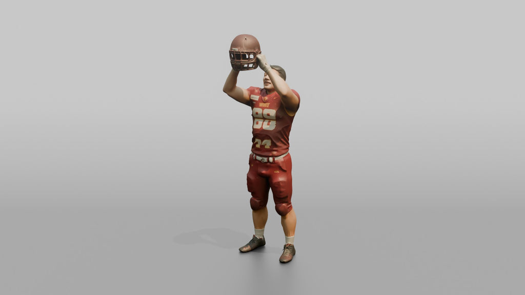 Player Raising His Helmet Triumphantly