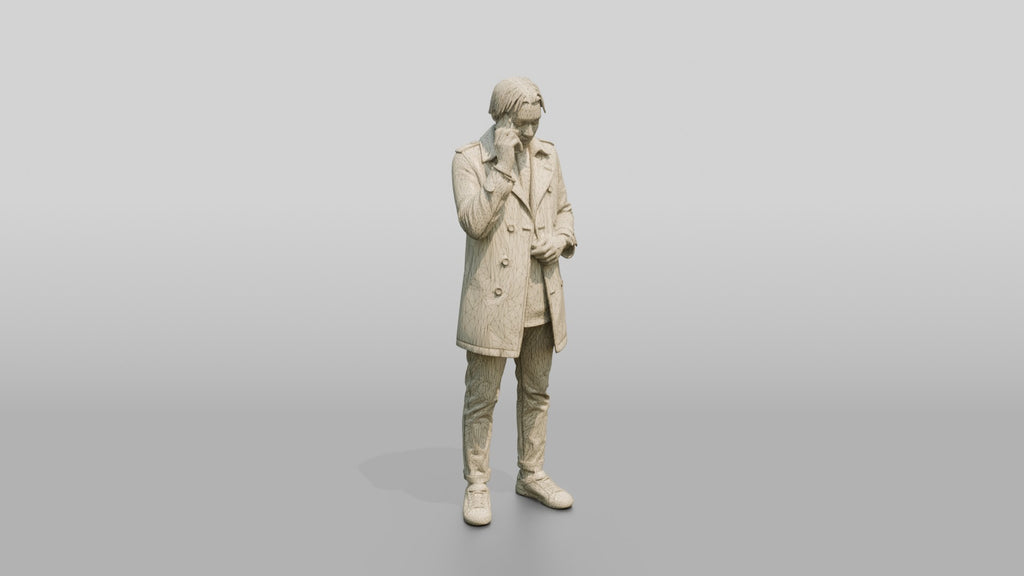 Stylish African Man in a Trench Coat on His Phone