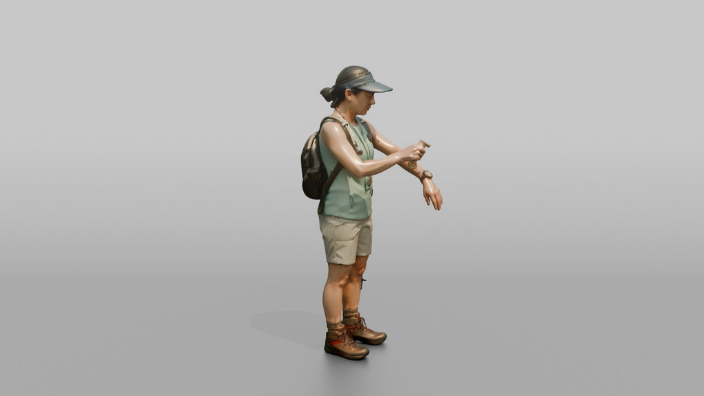 Hiker Applying Sunscreen to Her Arms