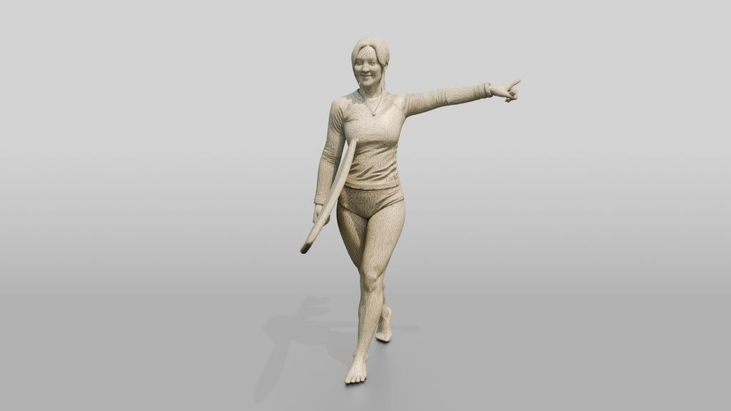 Woman Carrying Surfboard Toward the Waves