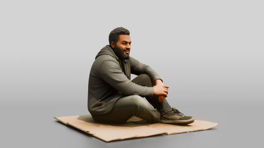 Homeless Man Sitting Flat on a Piece of Cardboard