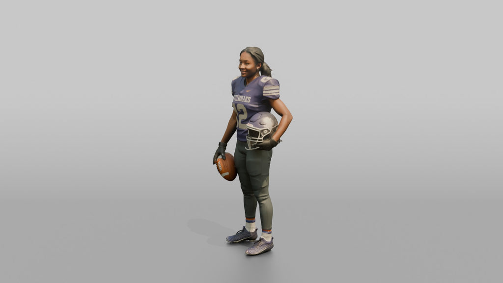 Wide Receiver Standing with the Ball at Her Side