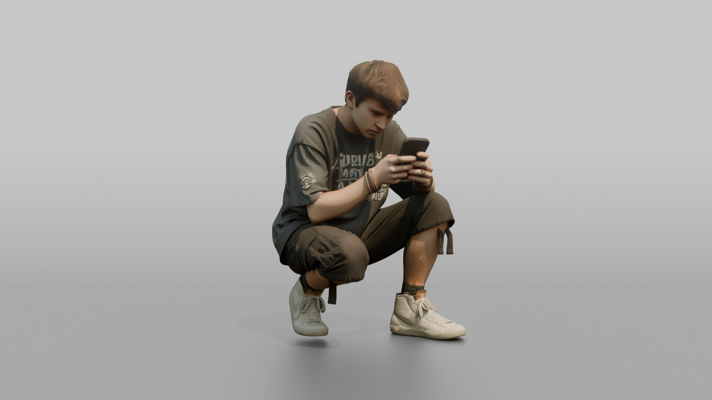 Teenage Boy Crouching to Look at His Phone