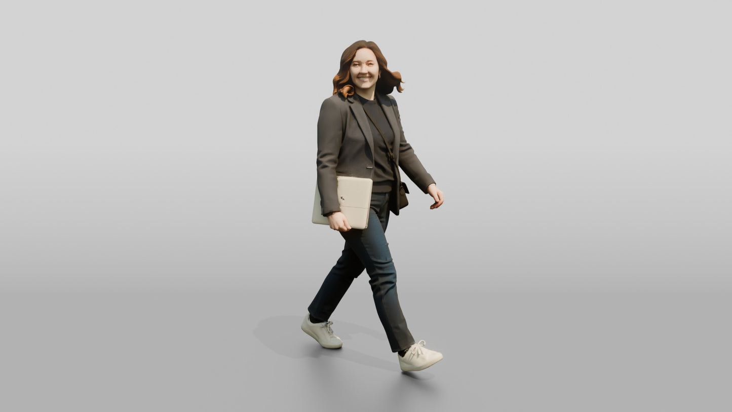 Businesswoman Walking with a Laptop