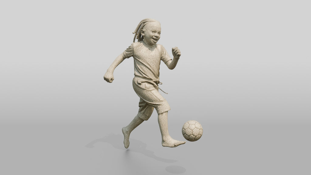 African Boy Playing Soccer in Patchwork Shorts