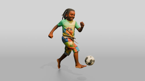 African Boy Playing Soccer in Patchwork Shorts