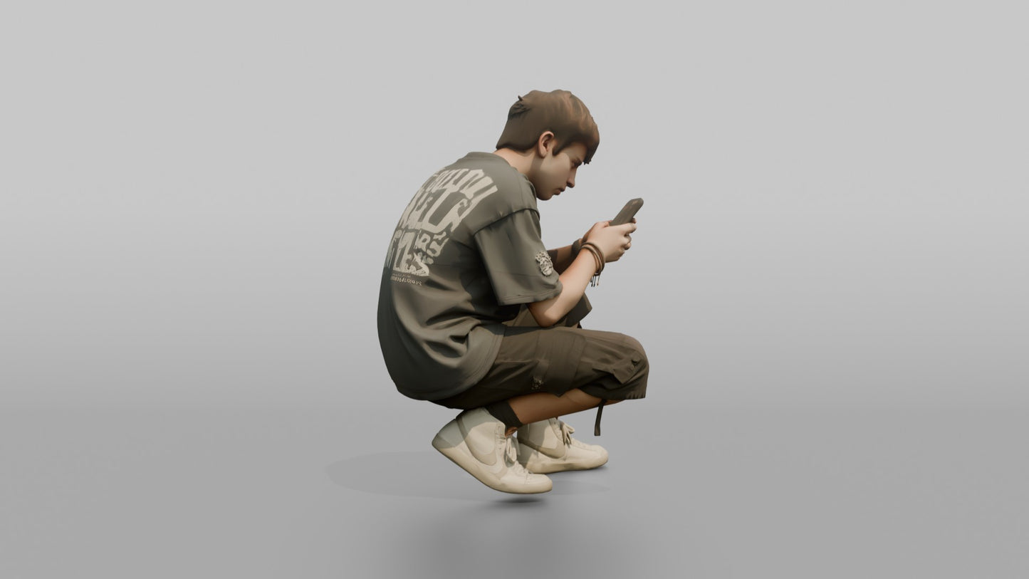Teenage Boy Crouching to Look at His Phone