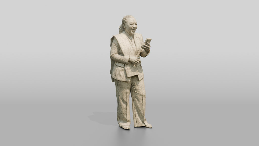 African Woman in a White Pantsuit Laughing at Her Phone