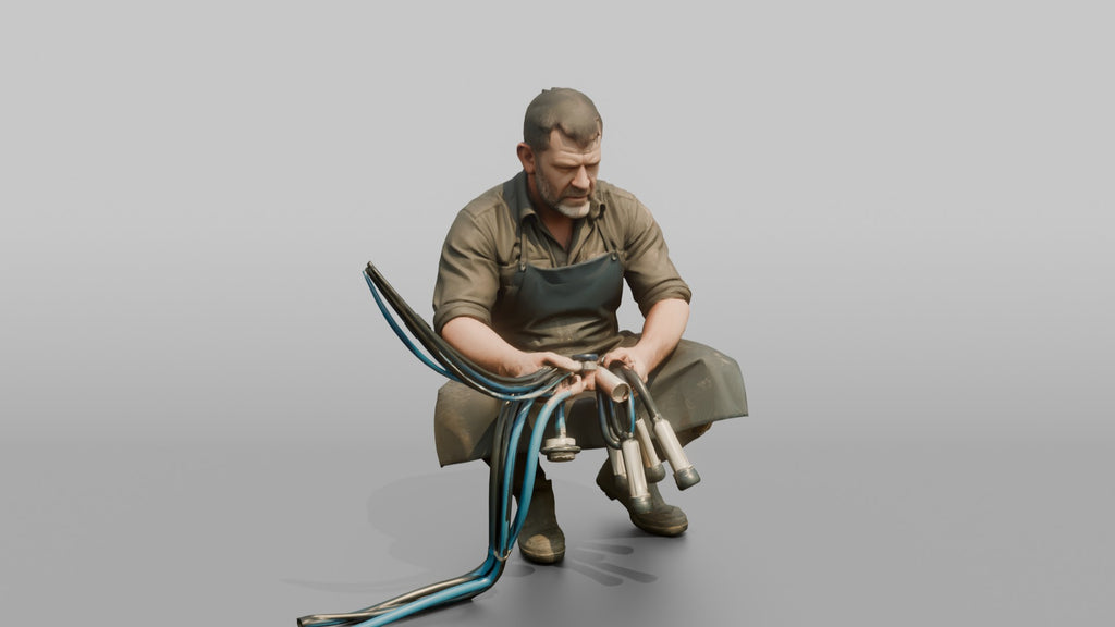 Farmer Crouching Down Holding Automated Milking Apparatus Equipment