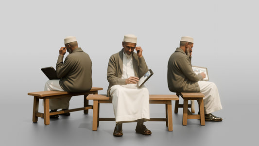 Elderly African Man Reading a Tablet on a Bench