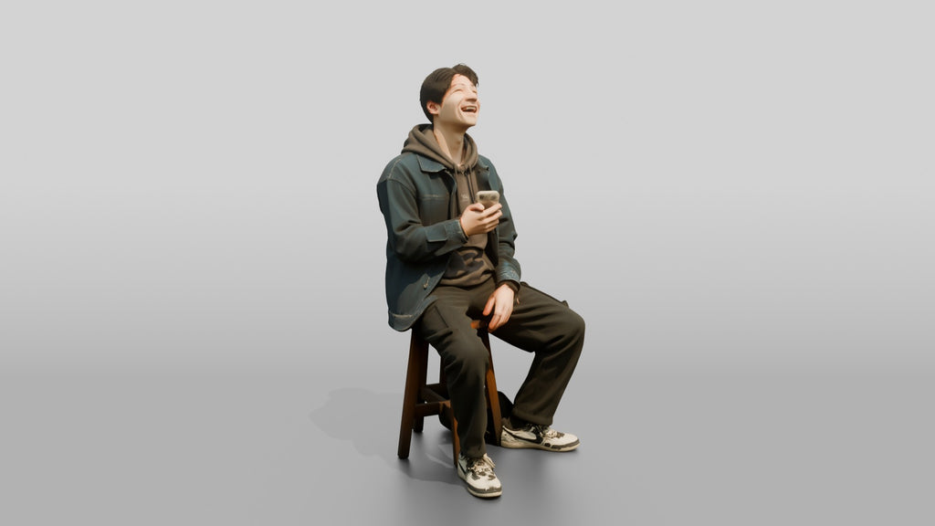 Asian Man Laughing at Phone