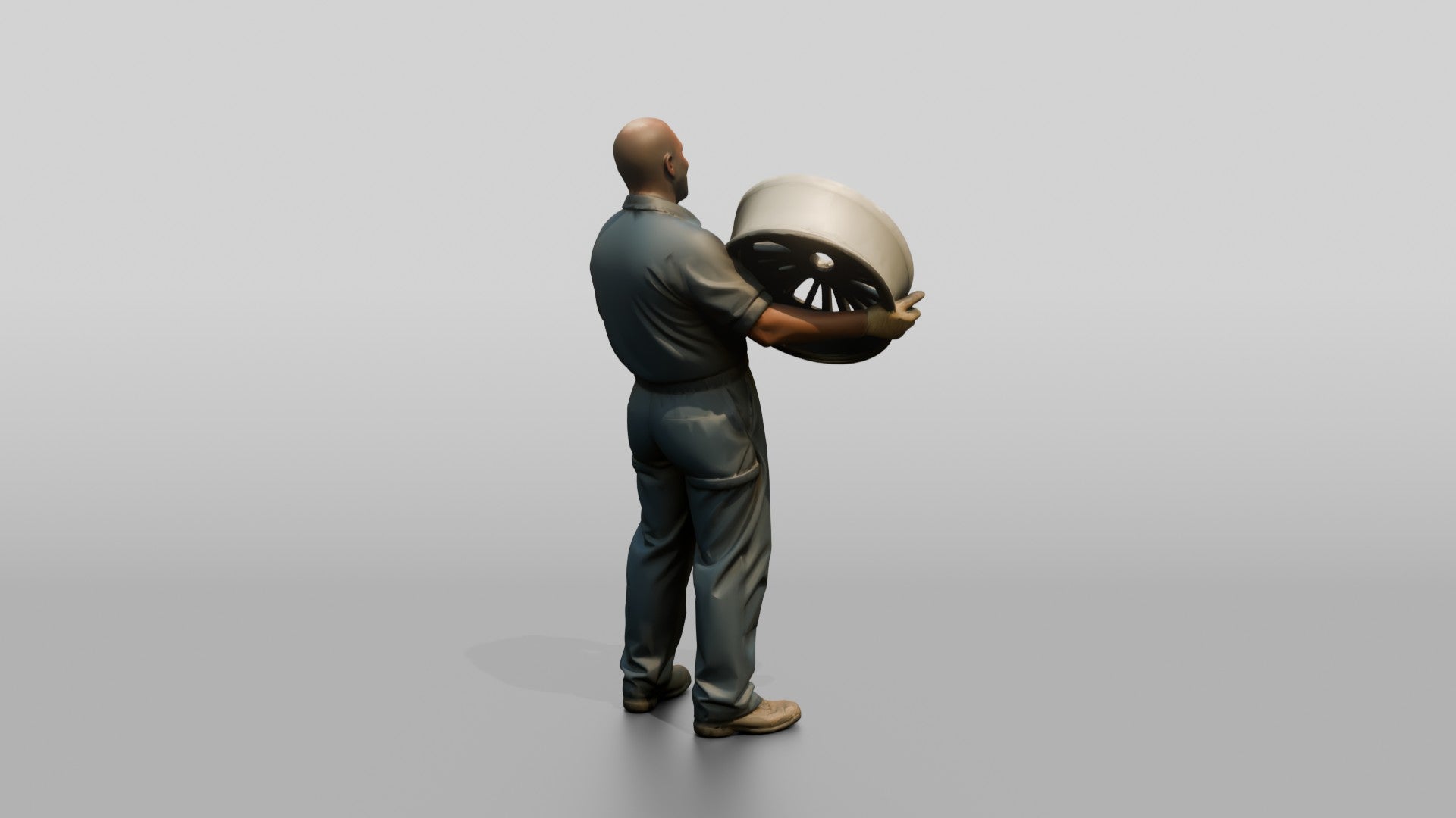 Mechanic Lifting an Alloy Wheel
