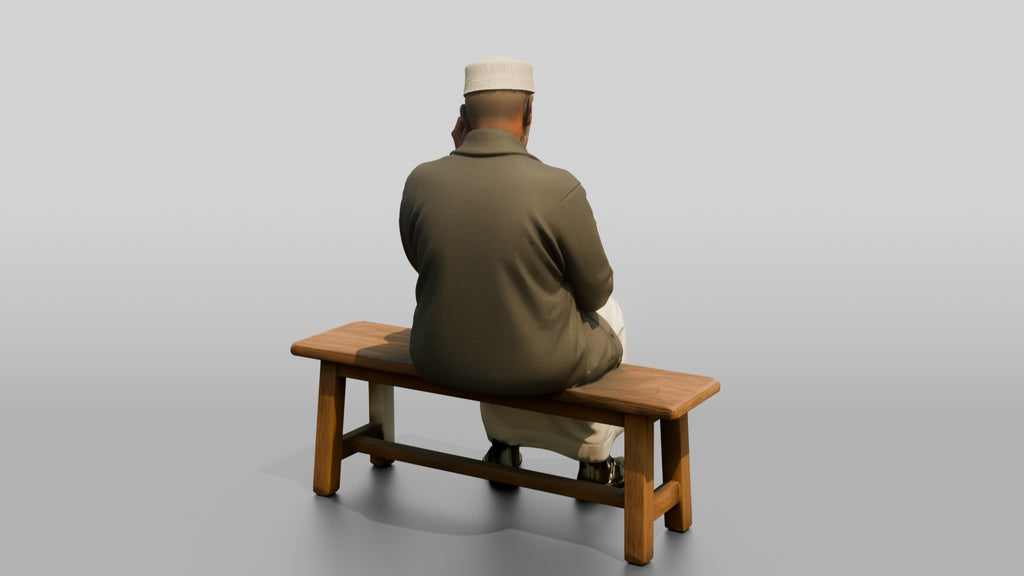 Elderly African Man Reading a Tablet on a Bench