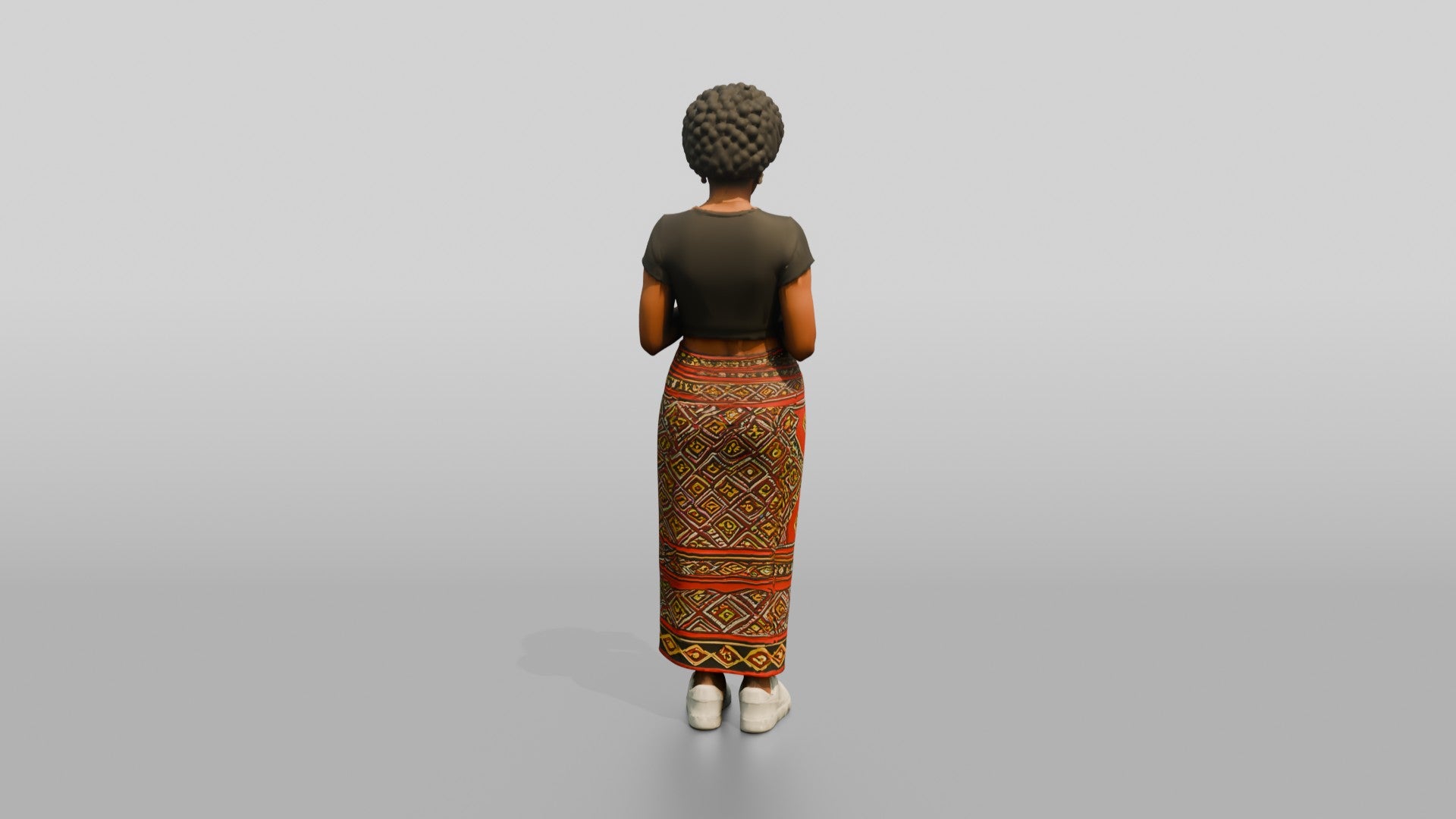 African Woman in a Wrap Skirt Looking at Her Phone