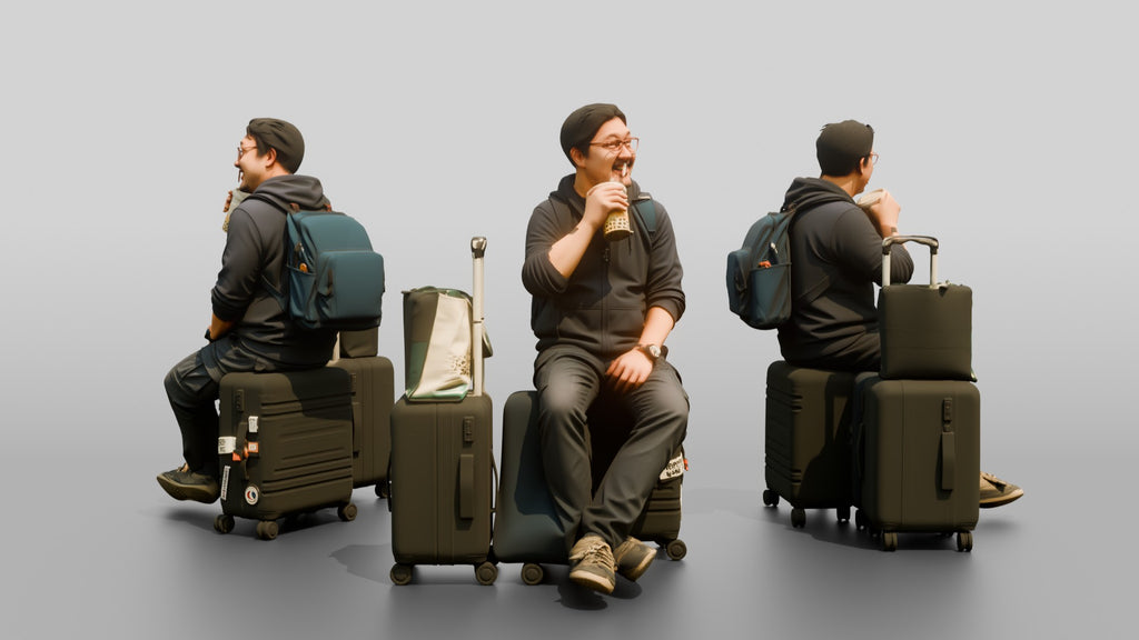 Plus-Size Asian Man Seated on Suitcase Drinking Bubble Tea