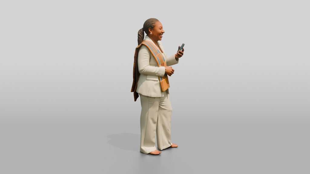 African Woman in a White Pantsuit Laughing at Her Phone