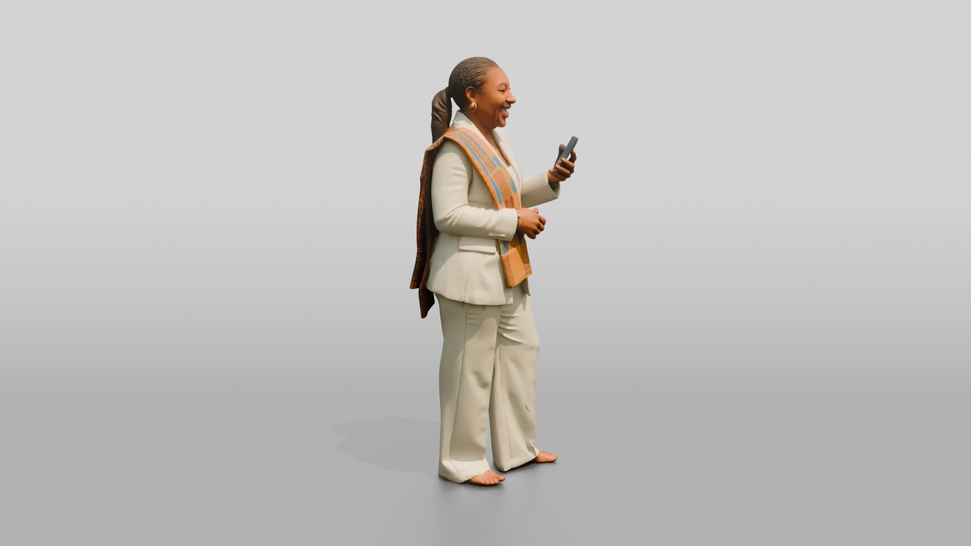 African Woman in a White Pantsuit Laughing at Her Phone