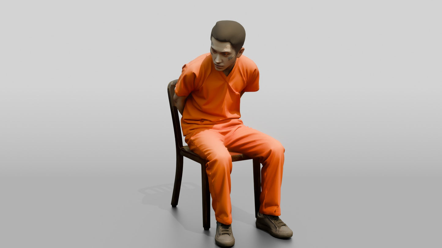 East Asian Male Prisoner Sitting Slouched in a Metal Chair