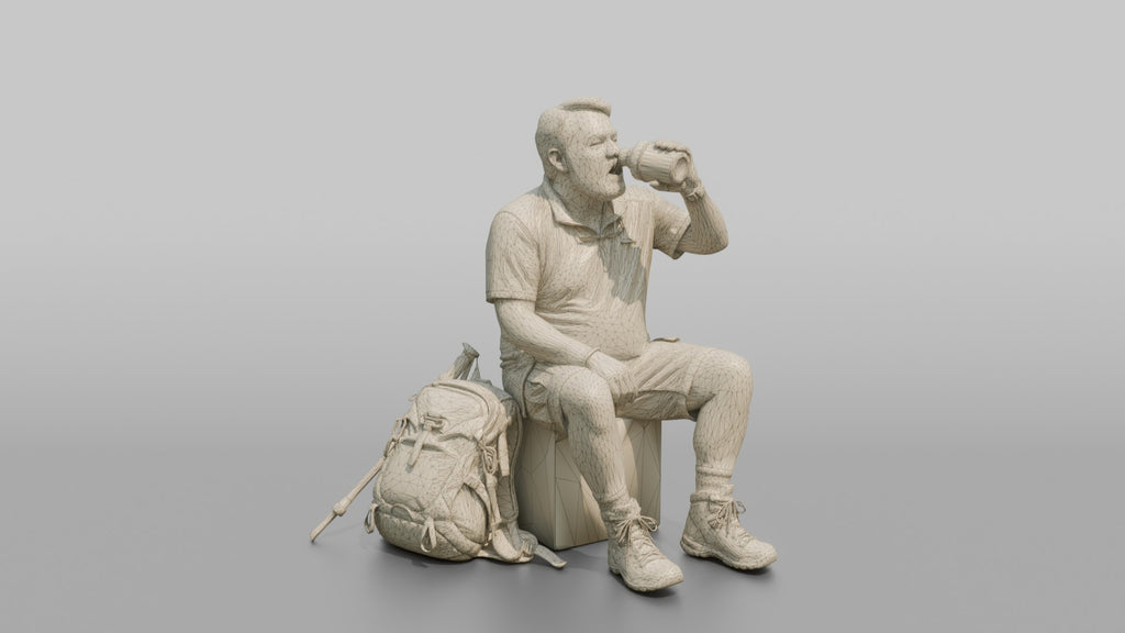 Hiker Sitting and Drinking from a Canteen