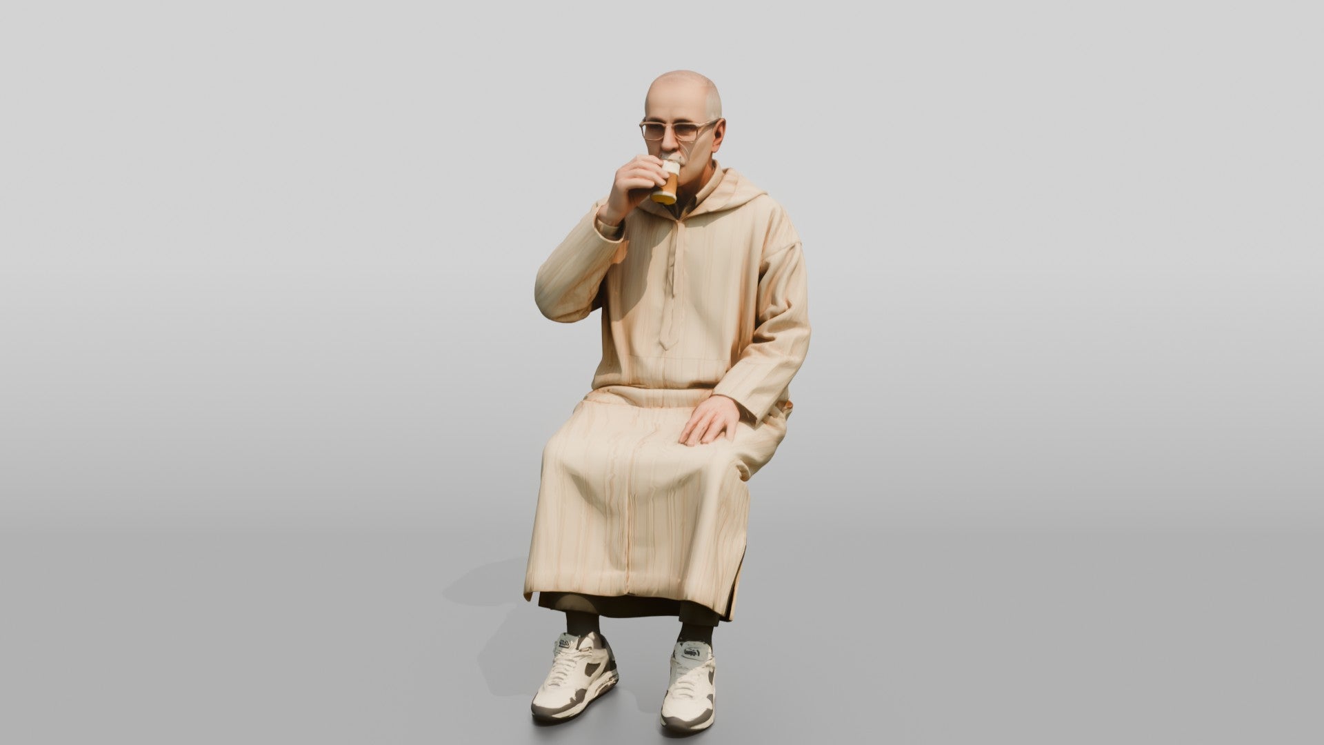 Elderly African Man in a Djellaba Sitting and Drinking Tea