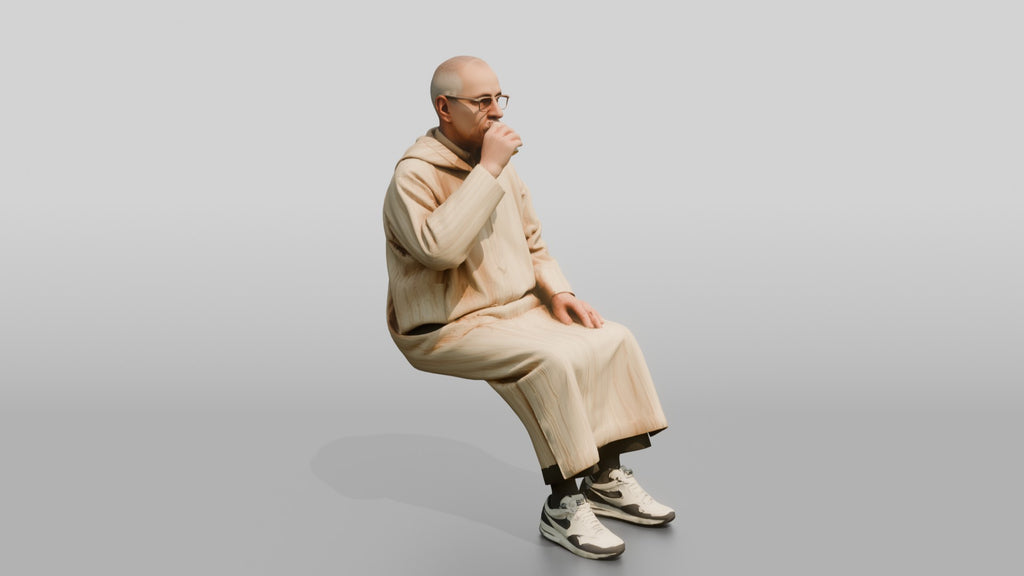 Elderly African Man in a Djellaba Sitting and Drinking Tea