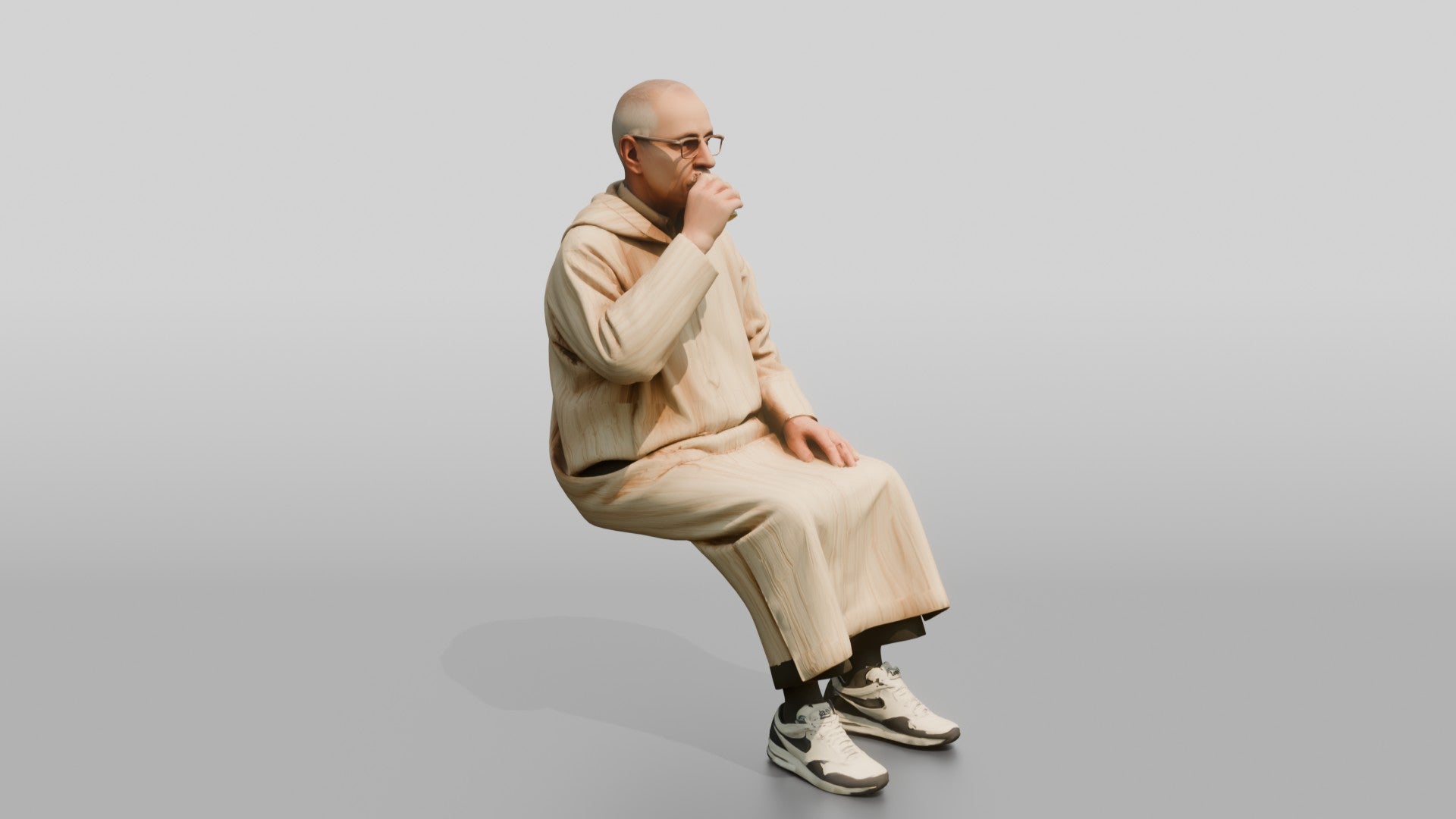 Elderly African Man in a Djellaba Sitting and Drinking Tea