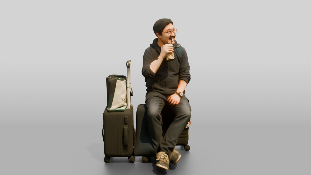 Plus-Size Asian Man Seated on Suitcase Drinking Bubble Tea