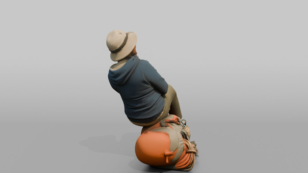 Hiker Sitting on Her Backpack, Taking a Break