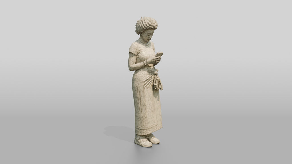 African Woman in a Wrap Skirt Looking at Her Phone