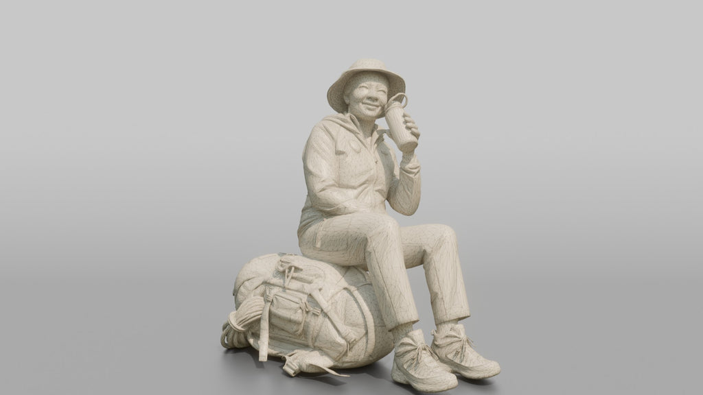 Hiker Sitting on Her Backpack, Taking a Break