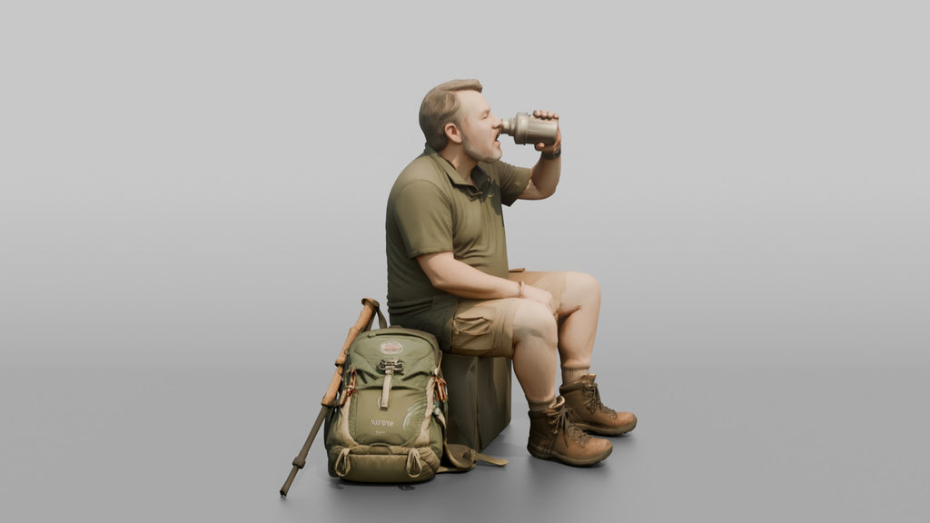 Hiker Sitting and Drinking from a Canteen