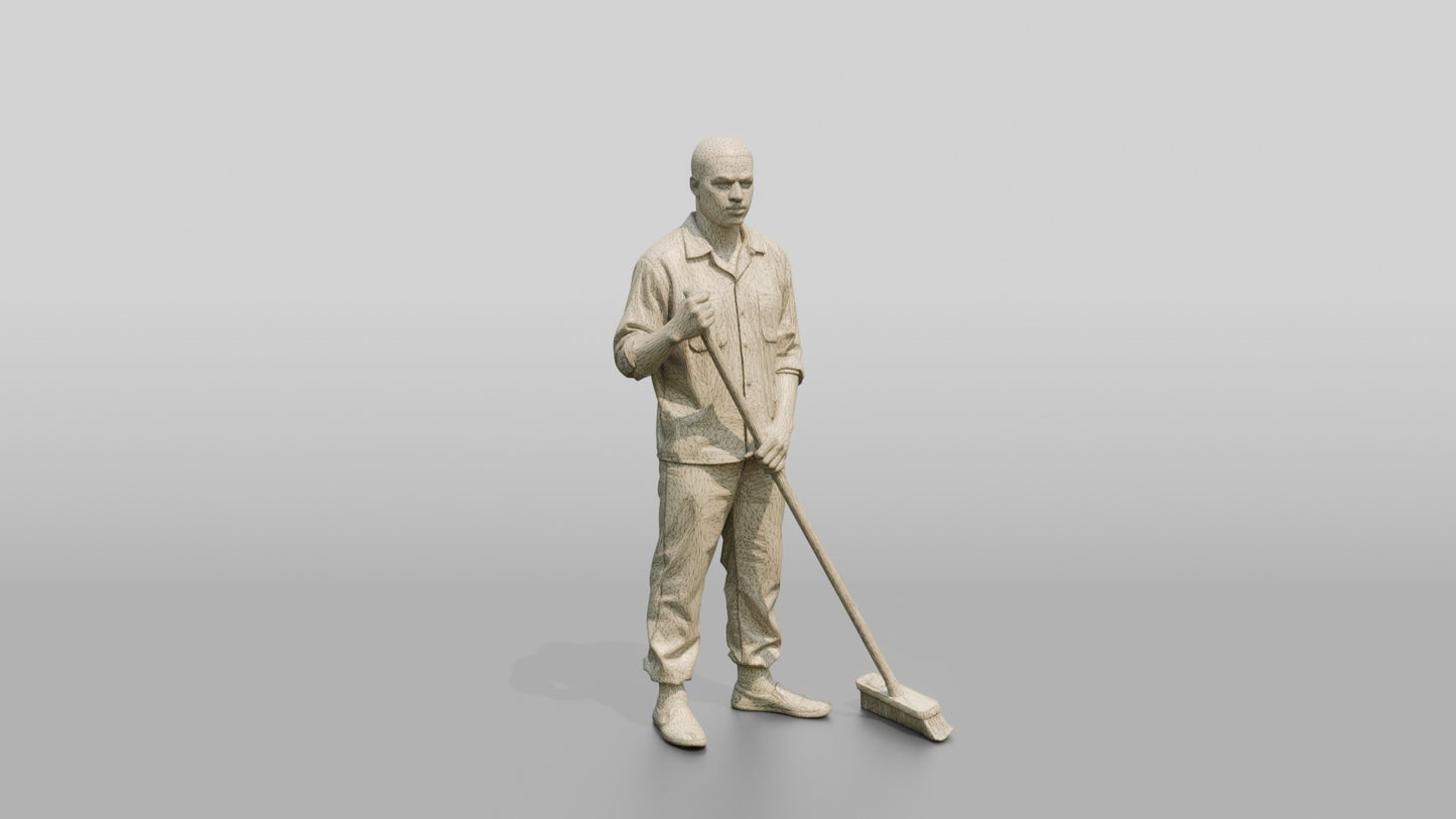 Black Male Prisoner in a Dark Green Uniform Holding a Push-broom