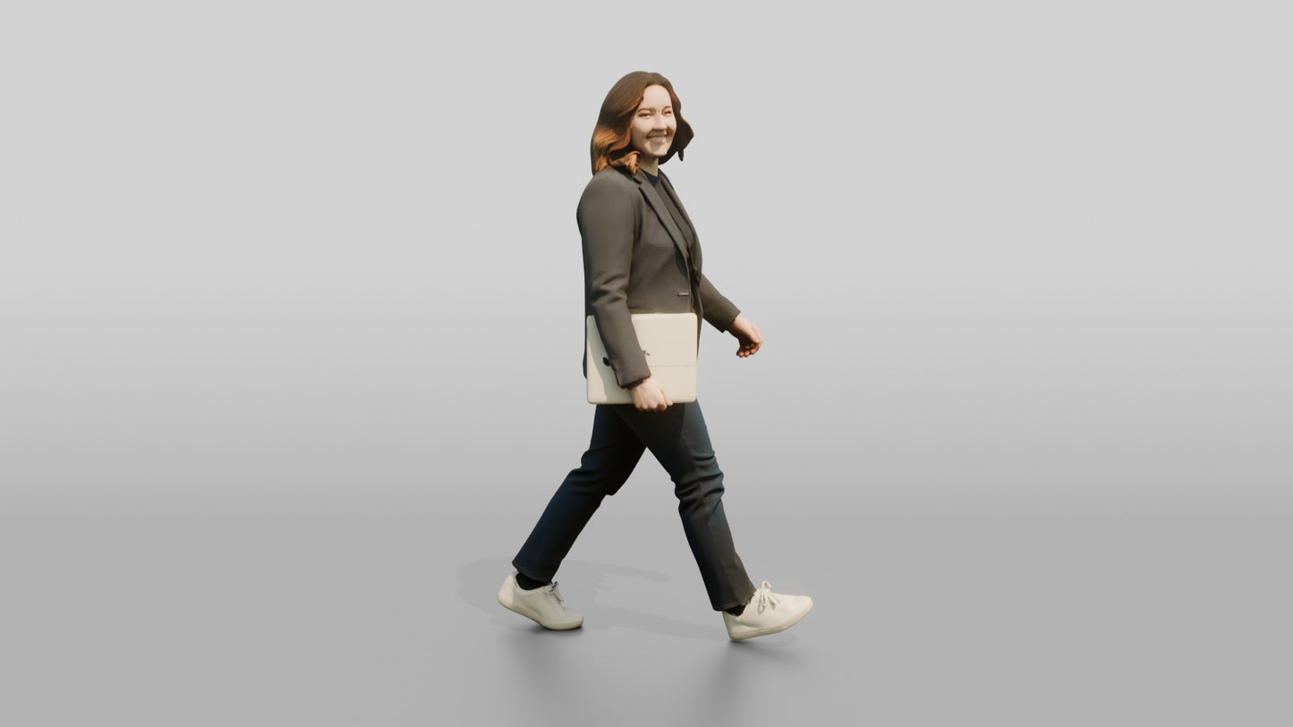Businesswoman Walking with a Laptop