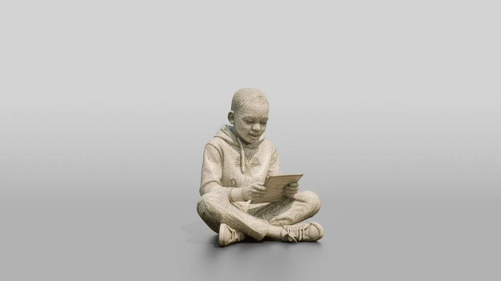 African Boy Sitting Cross-Legged with a Tablet