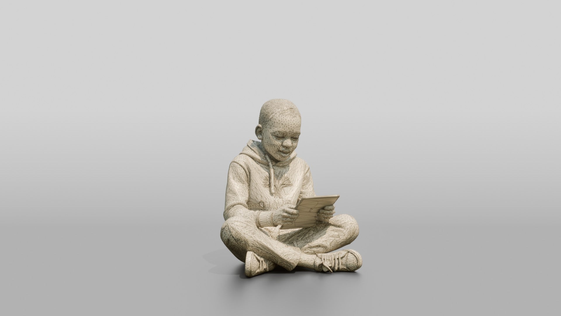 African Boy Sitting Cross-Legged with a Tablet