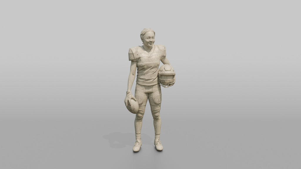 Wide Receiver Standing with the Ball at Her Side