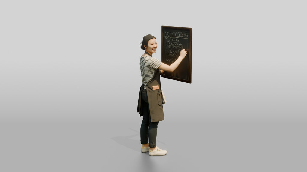 East Asian Woman Barista Writing Chalk Menu