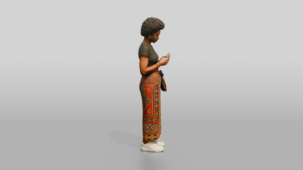 African Woman in a Wrap Skirt Looking at Her Phone