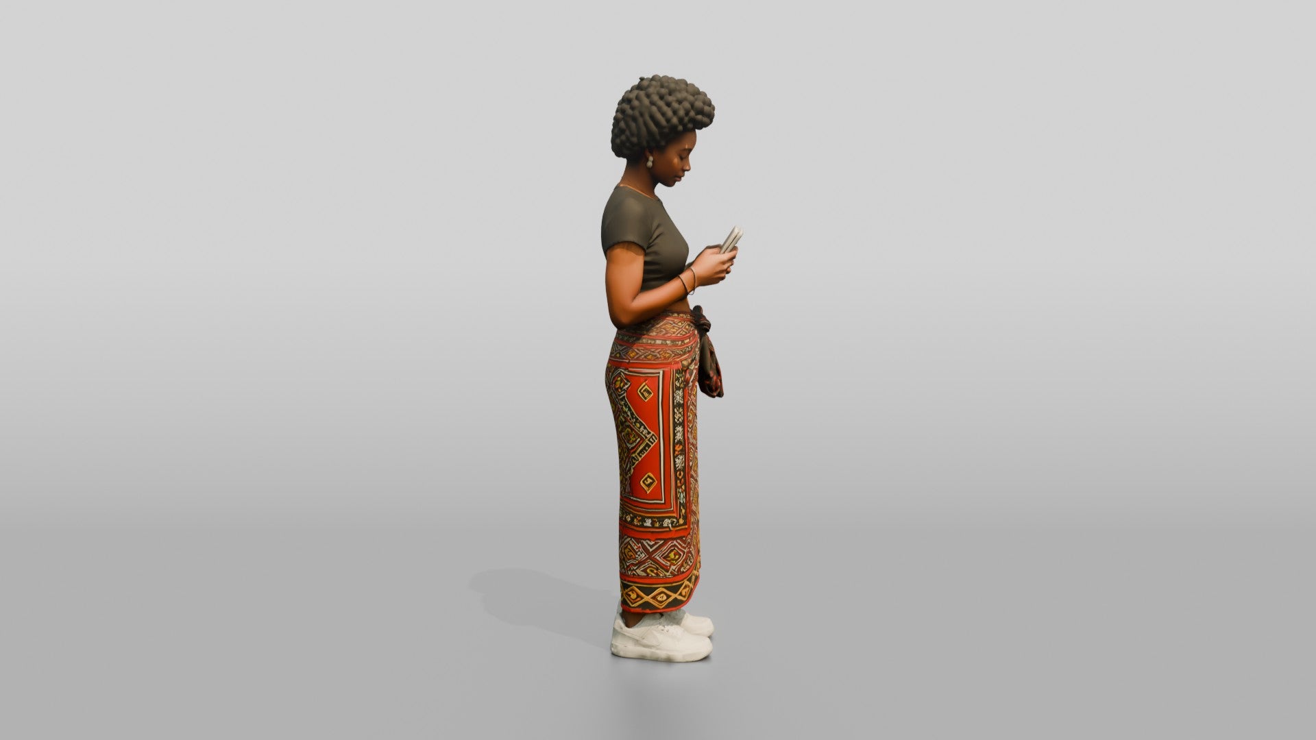African Woman in a Wrap Skirt Looking at Her Phone