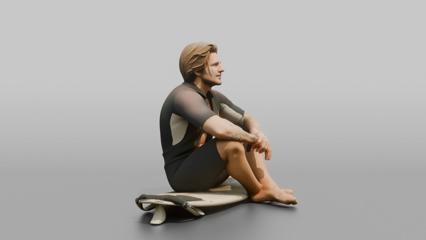 Surfer Sitting on His Surfboard