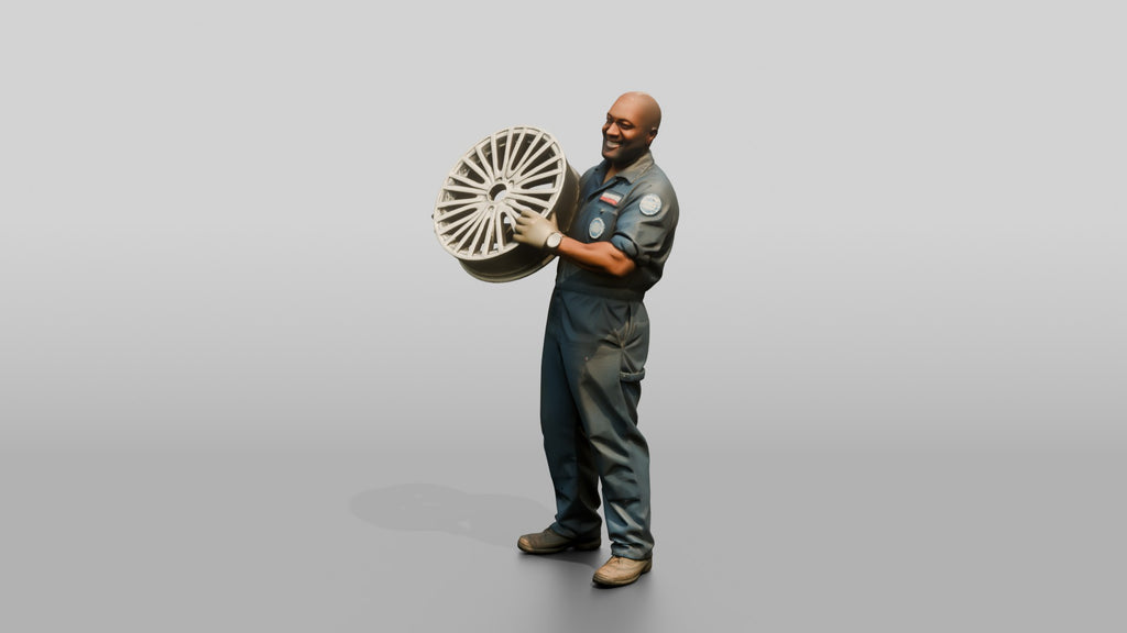 Mechanic Lifting an Alloy Wheel