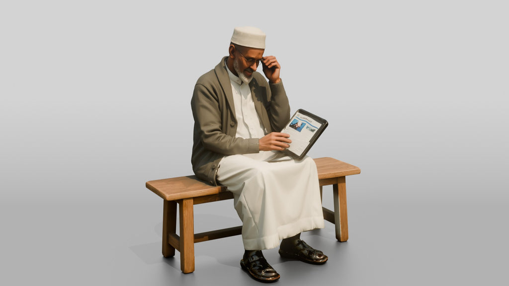 Elderly African Man Reading a Tablet on a Bench