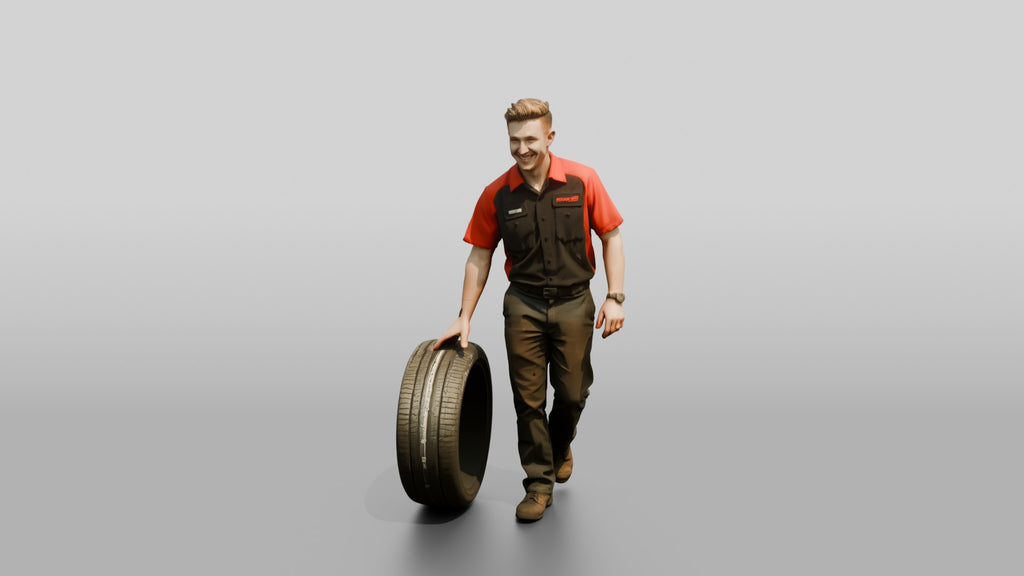 Mechanic Rolling a Performance Tire