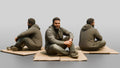 Homeless Man Sitting Flat on a Piece of Cardboard
