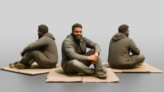 Homeless Man Sitting Flat on a Piece of Cardboard