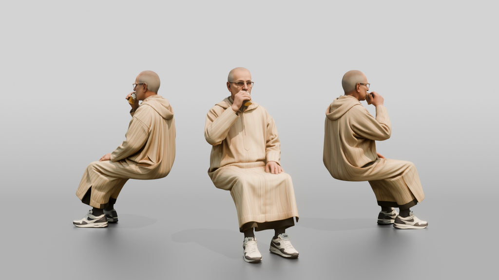 Elderly African Man in a Djellaba Sitting and Drinking Tea