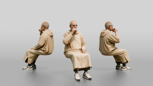 Elderly African Man in a Djellaba Sitting and Drinking Tea