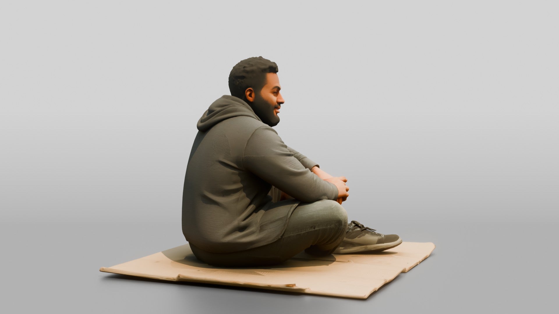 Homeless Man Sitting Flat on a Piece of Cardboard